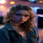 A photorealistic image of a young actress on a movie set, surrounded by cameras and lights, with a conflicted expression. The background shows a Hollywood studio with Disney-like elements, but the atm