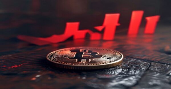Bitcoin bajo los 79.000 dólares: ¿señal de consolidación o corrección profunda? 2 A photorealistic image of a Bitcoin physical coin resting on a wooden table, with a downward red arrow chart superimposed in the background, soft lighting, dark ambiance, no text.