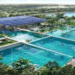 A photorealistic aerial view of a modern public swimming pool complex with solar panels on the roof, surrounded by lush greenery, clear blue water, and people swimming. The pool area shows water-savin