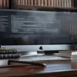 A sleek, modern low-cost law office with a large computer screen displaying an AI-generated divorce agreement, next to a stack of traditional law books and a gavel. Photorealistic, no text.